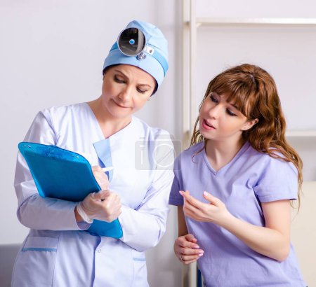 Photo for The young woman visiting female doctor otolaryngologist - Royalty Free Image