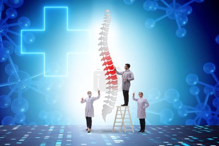 Photo for Medical concept with doctors and the spine - Royalty Free Image