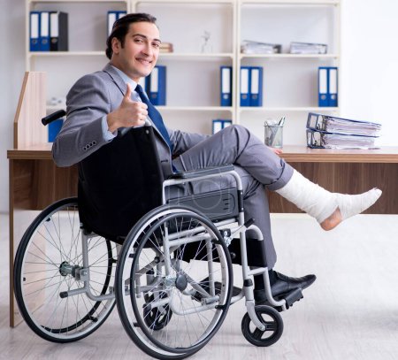 Photo for The male employee in wheel-chair in the office - Royalty Free Image