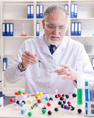 Photo for The old male chemist working in the lab - Royalty Free Image