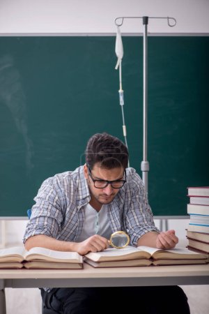 Photo for Young teacher suffering in the classroom - Royalty Free Image