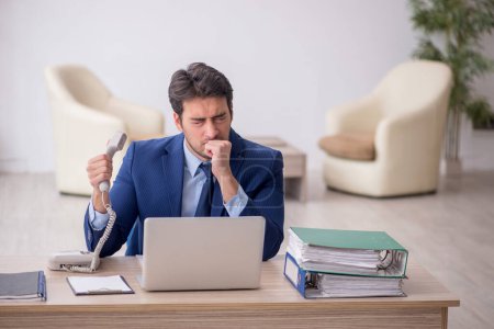 Young businessman employee sitting at workplace