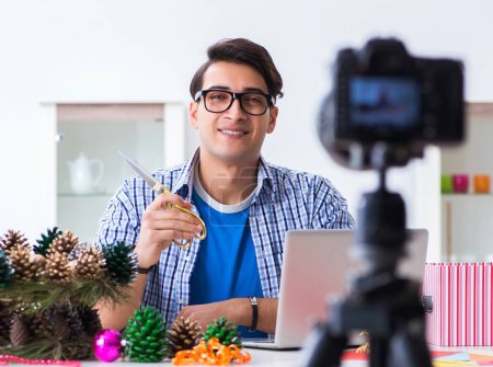 Photo for The young vlogger recording video doing christmas decoration - Royalty Free Image