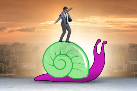 Businessman with snail in the slow business concept
