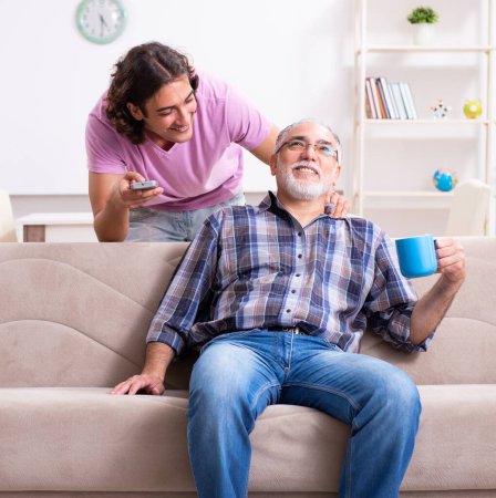 Photo for The young student and his old grandpa at home - Royalty Free Image