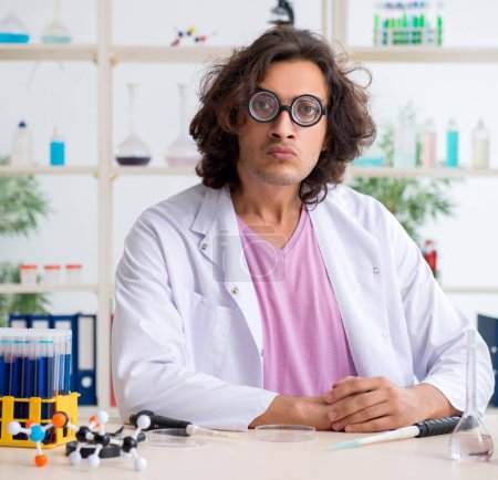 Téléchargez les photos : Le chimiste masculin drôle travaillant dans le laboratoire - en image libre de droit