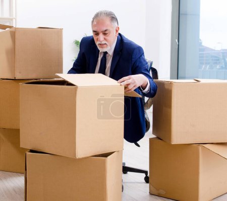The aged businessman moving to new workplace