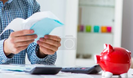 Photo for The young couple looking at family finance papers - Royalty Free Image