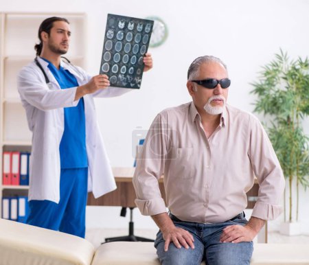 Photo for Old man visiting young male doctor - Royalty Free Image