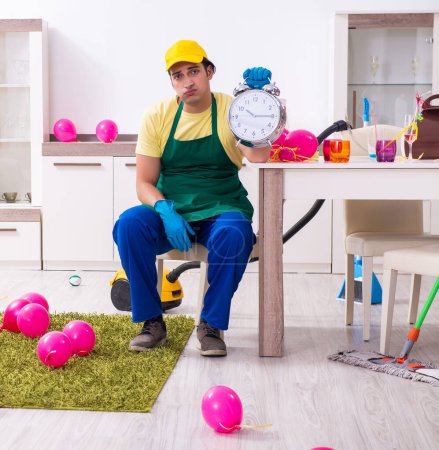 Photo for The young male contractor doing housework after party - Royalty Free Image