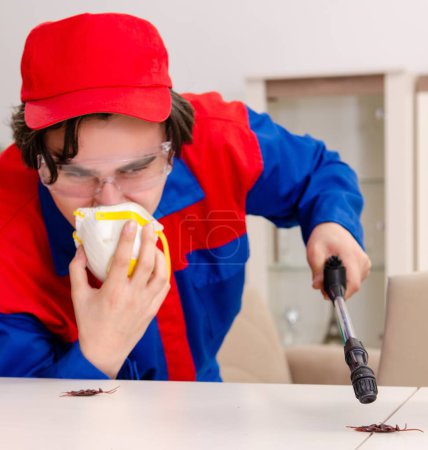 Photo for The young contractor doing pest control at home - Royalty Free Image