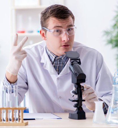 Photo for The young chemist student experimenting in lab - Royalty Free Image