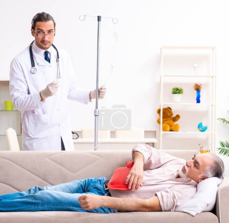 The young male doctor visiting old patient at home