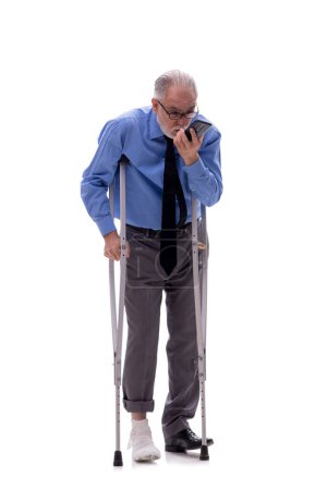 Photo for Old male boss with crutches isolated on white - Royalty Free Image