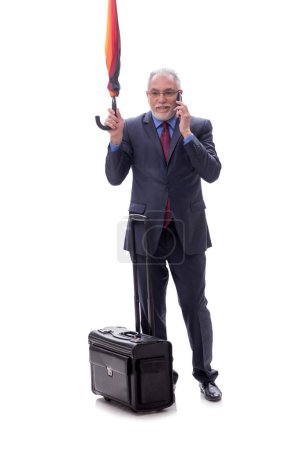 Photo for Businessman with an umbrella and luggage isolated on white - Royalty Free Image