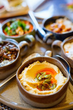 Téléchargez les photos : Selection of traditional turkish appetizers including hummus with pumpkin seeds - en image libre de droit