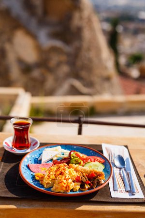 Photo for Delicious Turkish breakfast with scrambled eggs served outdoors - Royalty Free Image