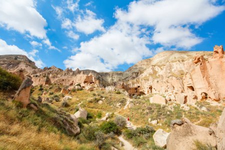 Foto de Family of mother and teenage daughter walking among beautiful rock formations enjoying stunning nature landscape in Cappadocia Turkey - Imagen libre de derechos