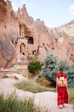 Photo for Young woman walking in Zelve valley in Cappadocia Turkey among rock formations and fairy chimneys - Royalty Free Image