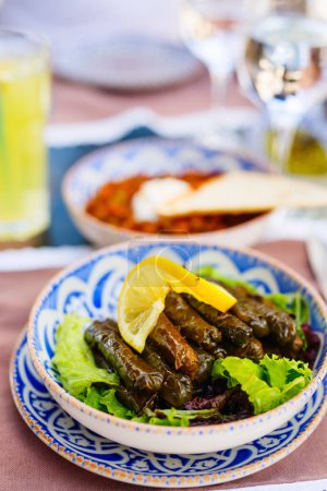Photo for Traditional turkish appetizer  stuffed grape leaves served in restaurant - Royalty Free Image