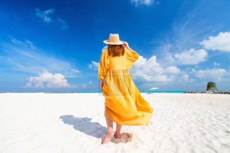 Photo for Young woman on white sand tropical beach in Maldives enjoying vacation - Royalty Free Image