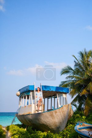 Photo for Young woman on white sand tropical beach in Maldives enjoying vacation - Royalty Free Image