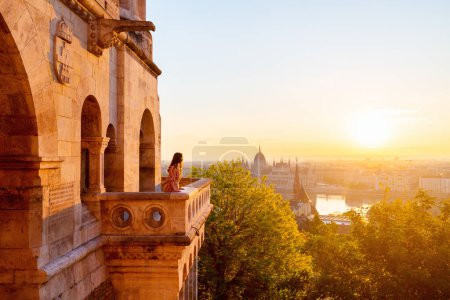 Photo for Beautiful caucasian woman enjoying morning view over Parliament in Budapest from Fisherman Bastion balcony - Royalty Free Image
