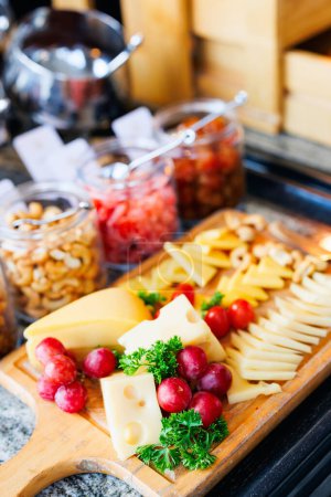Photo for Appetizers platter with cheese, grapes and cherry tomatoes served in a restaurant - Royalty Free Image