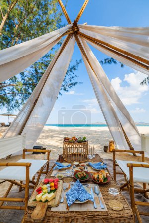 Photo for Luxury picnic on beautiful white sand beach at sunset - Royalty Free Image