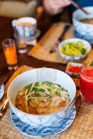 Photo for Pho Bo Vietnamese fresh rice noodle soup with beef - Royalty Free Image