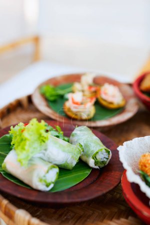 Photo for Traditional vietnamese spring rolls served with other small bites for lunch - Royalty Free Image