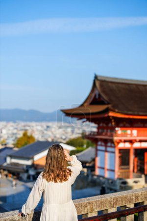 Back view of beautiful woman at Kiyomizu-dera temple in Kyoto at early morning