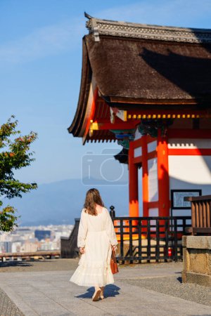 Back view of beautiful woman at Kiyomizu-dera temple in Kyoto at early morning