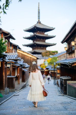 Back view of beautiful woman walking in Gion Kyoto at early morning