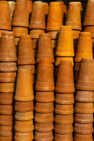 Stack of traditional terracotta earthen tumblers used for serving lassi drink or masala chai in India