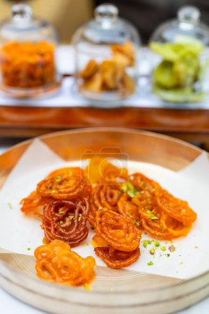 Photo for Jalebis coated in sugar syrup delicious Indian dessert food served for breakfast at luxury resort or restaurant - Royalty Free Image