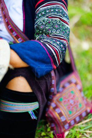 Foto de Close up of black Hmong woman traditional embroidered clothes - Imagen libre de derechos