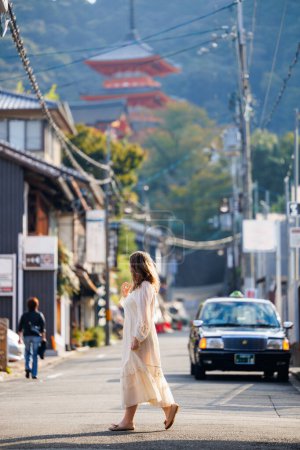 Photo for Beautiful woman walking on streets of Kyoto - Royalty Free Image