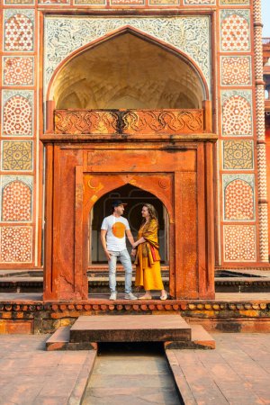 Beautiful couple enjoying vacation in India visiting Sikandra Akbar tomb attraction in Agra