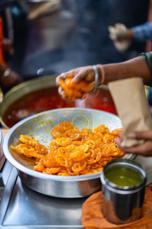 Photo for Jalebis coated in sugar syrup delicious Indian dessert street food - Royalty Free Image