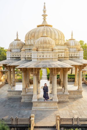 Photo for Beautiful woman enjoying vacation in India visiting Maharani Ki Chhatri complex in Jaipur - Royalty Free Image