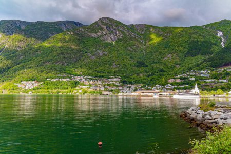 Photo for Small town of Odda.  Magical late summer sunset illuminates the city and the water.  Magnificent Hardanger fjord between forested mountains. Travel to Norway in summer. - Royalty Free Image