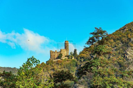 Photo for Medieval romantic castles and ruins. Warm autumn in Germany. Beautiful wooded slopes of the coastal hills of the river Rhine. The magnificent and scenic Castle Mouse. - Royalty Free Image