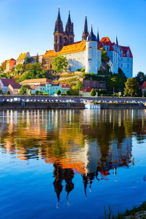 Foto de Autumn travel to Germany, Meissen. Meissen Cathedral with its beautiful Gothic architecture and the magnificent Albrechtsburg castle are reflected in the Elbe River. Warm sunny day - Imagen libre de derechos