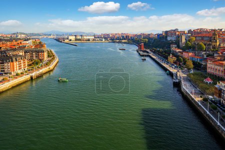 Photo for Portugalete, the district of Bilbao. Basque country. Flying ferry across the Nervion River. Photo taken from the ferry. European exotic. Magnificent colorful city with unusual architecture - Royalty Free Image