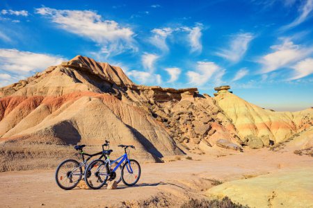 Photo for Couple of bicycles are parked. Bardenas Reales is a semi-desert area in the Spanish province of Navarre. The area has been declared a UNESCO Biosphere Reserve. - Royalty Free Image