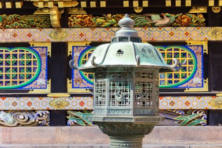 Photo for Magnificent stone lantern. Magnificent ornate temple. Japan.The temple and shrine of Nikko Tosho-gu is dedicated to the shogun Tokugawa Ieyasu. Building complex built in 1617. - Royalty Free Image