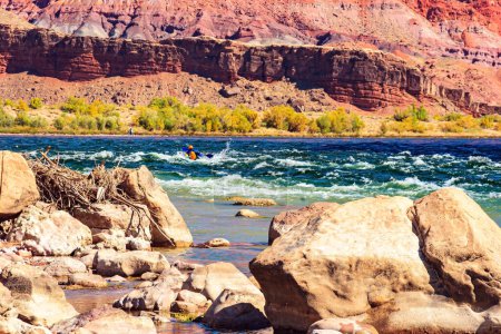 Photo for Stormy stream of water on stone rifts. Lees Ferry in the USA - the famous ferry crossing the Colorado River and the Grand Canyon in Arizona. Lovely warm sunny day. - Royalty Free Image