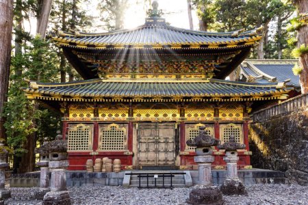 Photo for Sunset. Japan. Ornate temple with gilded roof. The temple and shrine of Nikko Tosho-gu is dedicated to the shogun Tokugawa Ieyasu. Building complex built in 1617. - Royalty Free Image