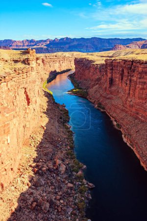 Photo for Deep and narrow canyon of the Colorado River. United States of America. The multicolored canyon of red Navajo sandstones. The water of the Colorado River reflects the surrounding rocks. - Royalty Free Image